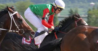 Jockey in Green Silks During Race