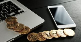 Bitcoin Tokens with Laptop and Smartphone