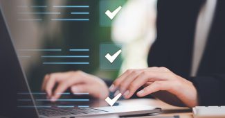 Businessperson Completing Checks on Laptop