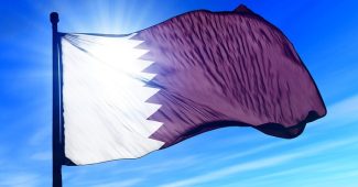 Qatar Flag Against Bright Sky