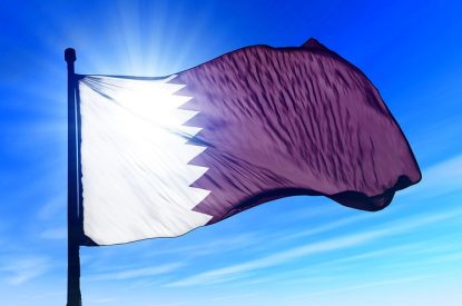 Qatar Flag Against Bright Sky