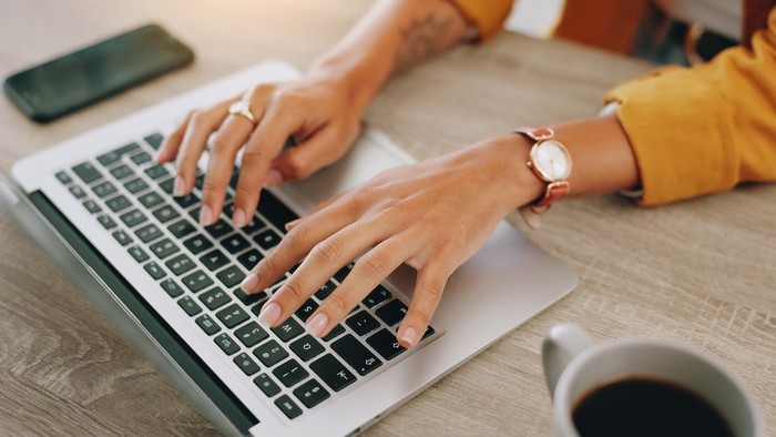 Hands of Woman Typing on Laptop