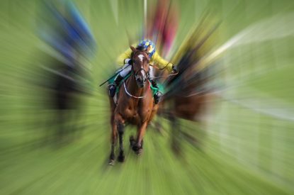 Jockey in Yellow Against Motion Blurred Race
