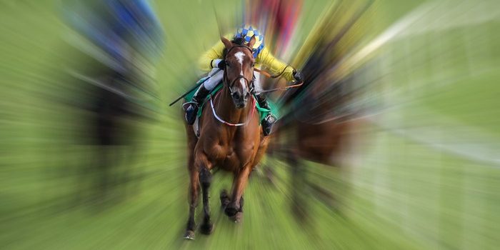 Jockey in Yellow Against Motion Blurred Race