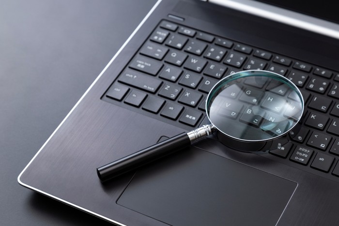 Laptop with Magnifying Glass