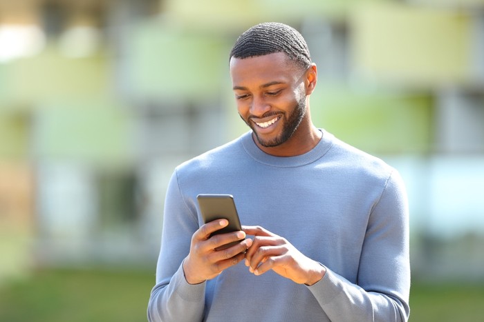 Smiling Man Holding Phone