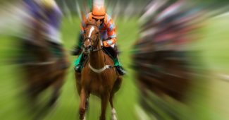 Jockey with Orange Silks in Motion Blurred Horse Race