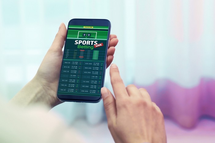 Woman Holding Smartphone with Live Sports Betting