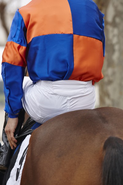 Jockey Wearing Blue and Orange Silks
