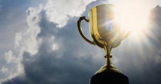 Gold Trophy Against Bright Cloudy Sky
