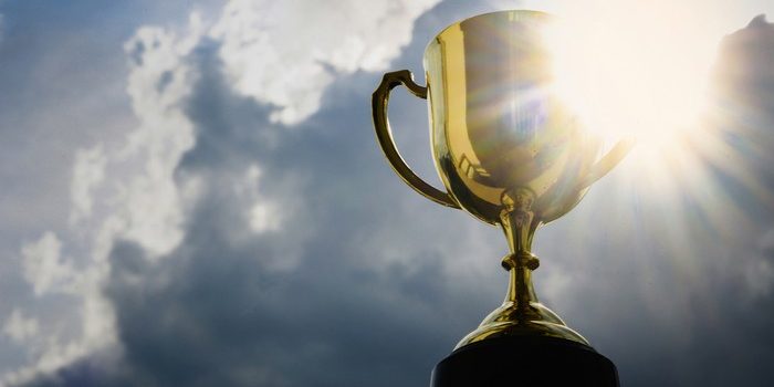 Gold Trophy Against Bright Cloudy Sky