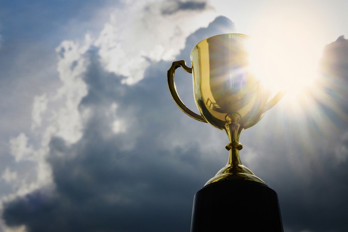 Gold Trophy Against Bright Cloudy Sky
